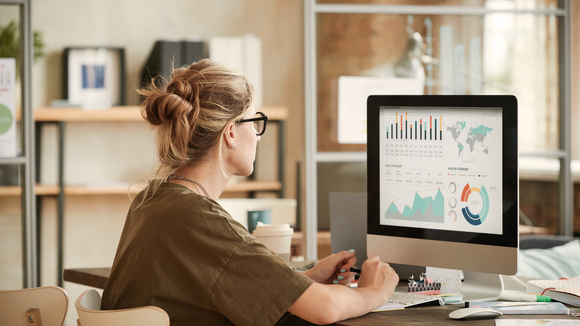 woman looking at graphs on computer