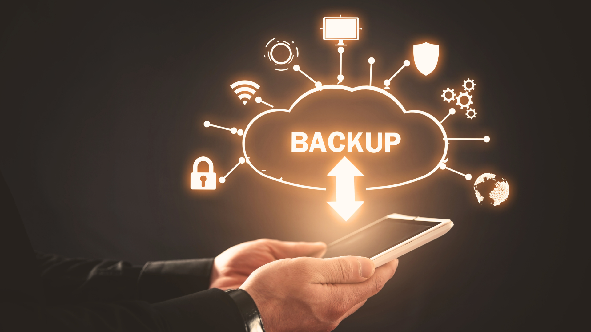 person holding a tablet with glowing icon on backup cloud and icons coming off it