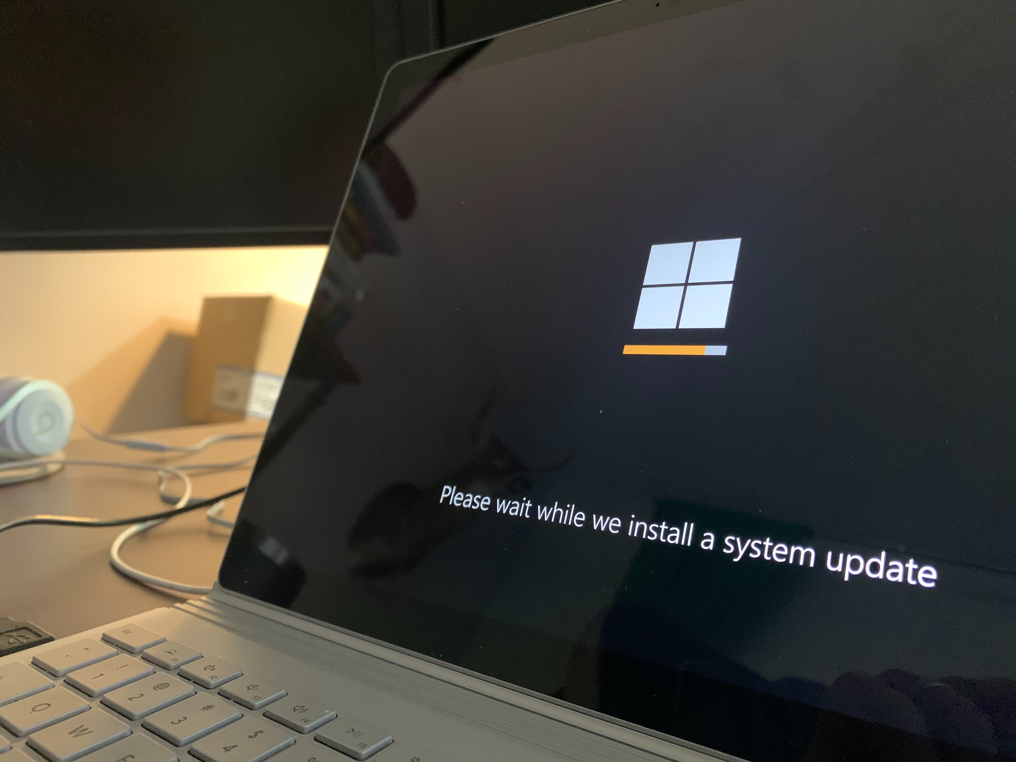 A laptop open with the Windows logo on the screen