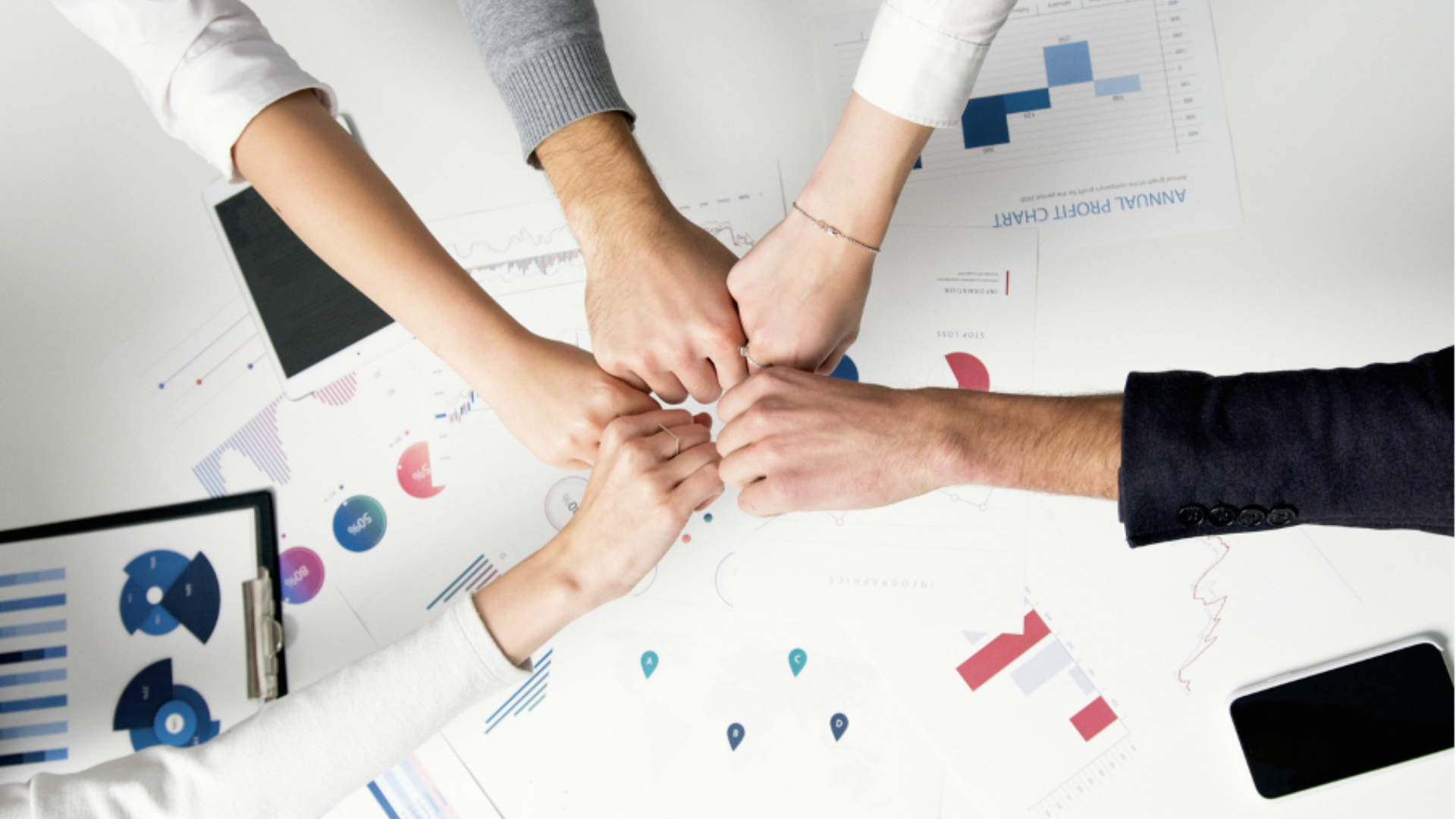 people in a circle fist bumping