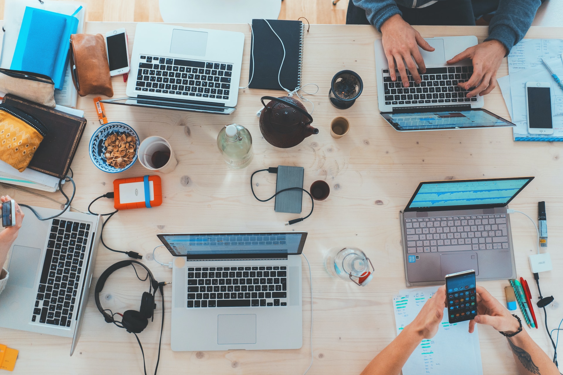 Laptops, headphones, smart phones on a table