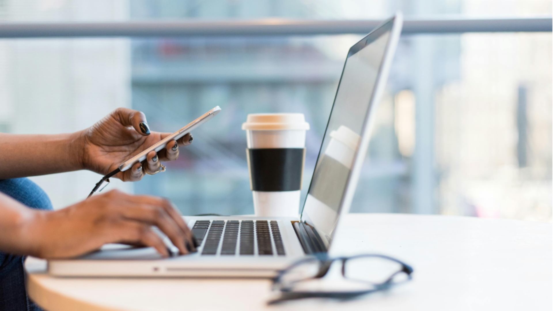 man working outside of office on laptop