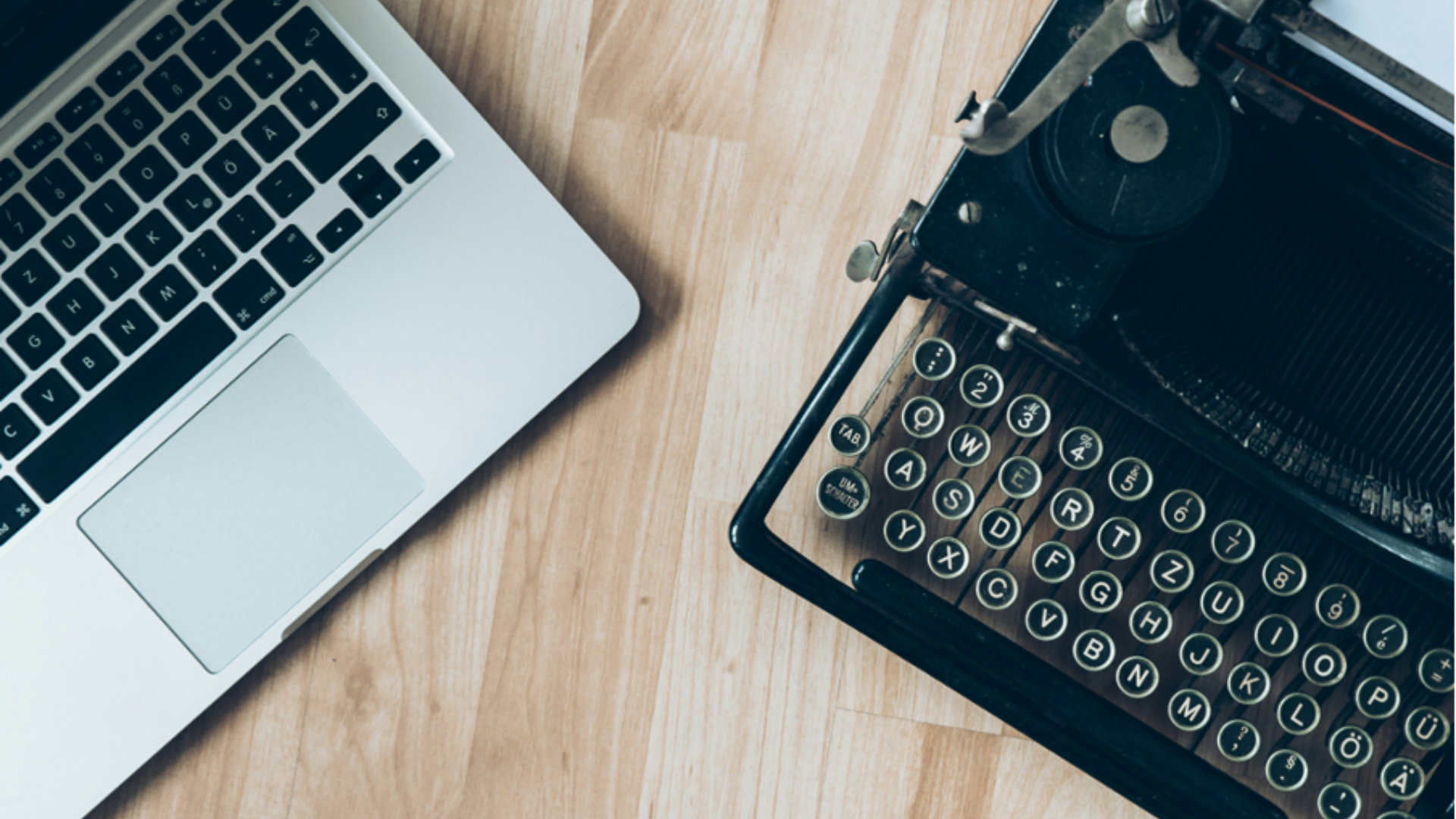 laptop next to a type writer