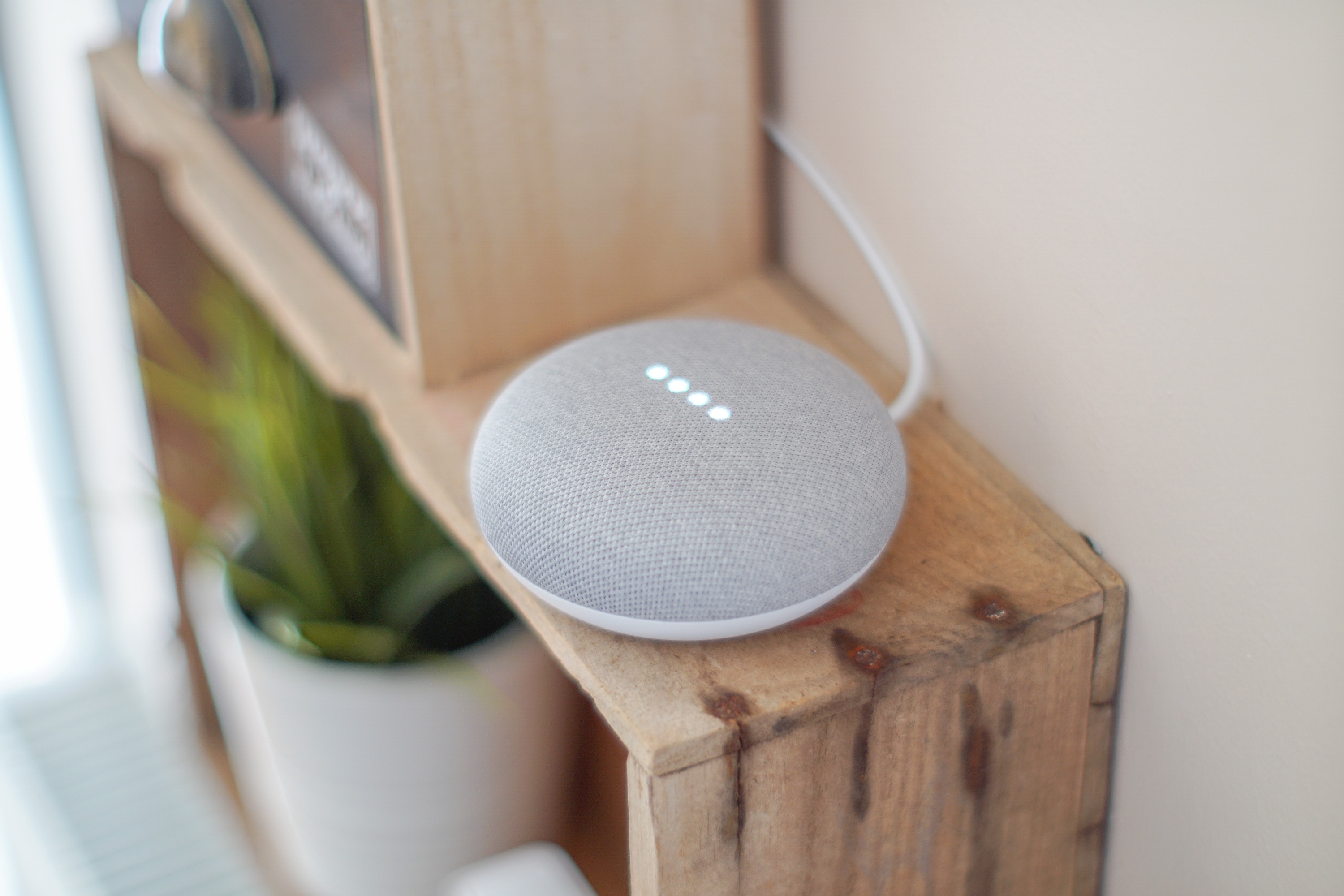 A smart home device sitting on a bookshelf