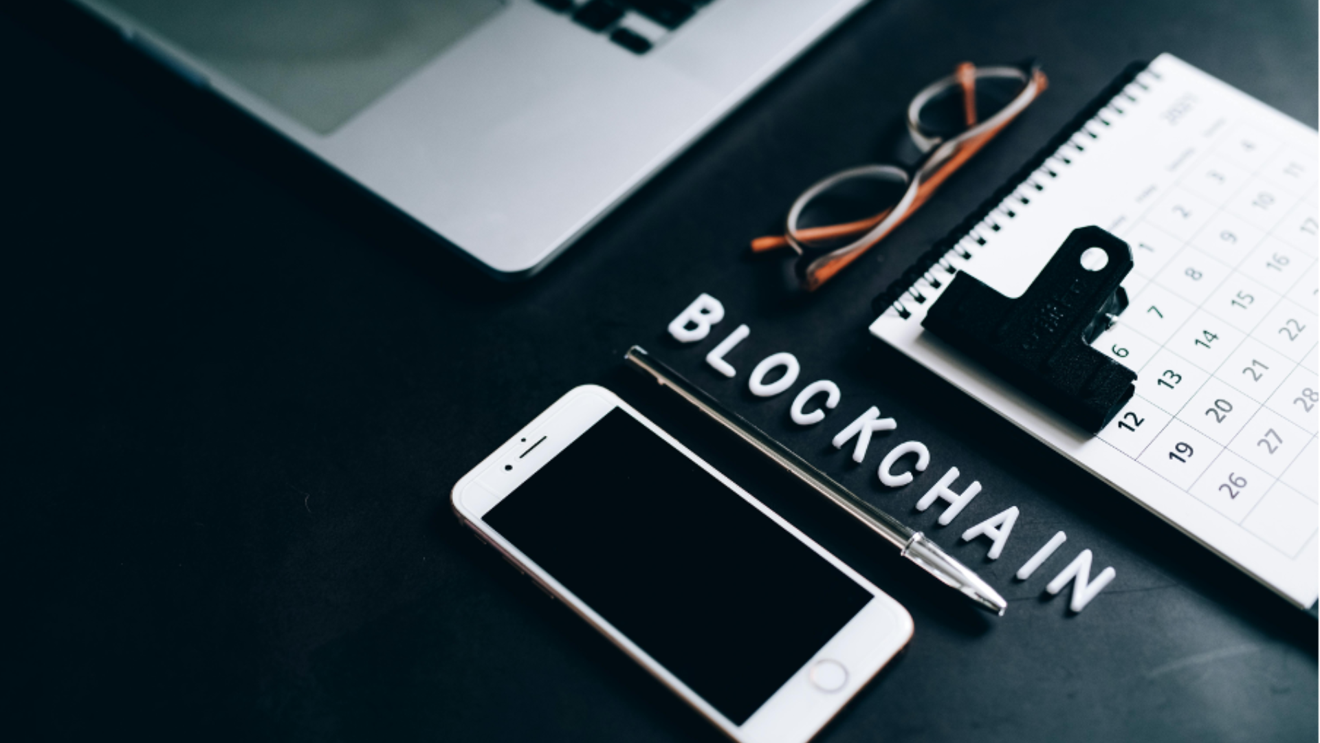 the word block chain next to a cell phone on a desk